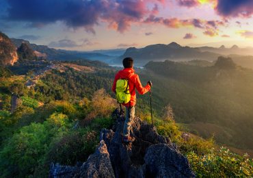 Backpacker standing on sunrise viewpoint at Ja Bo village, Mae h